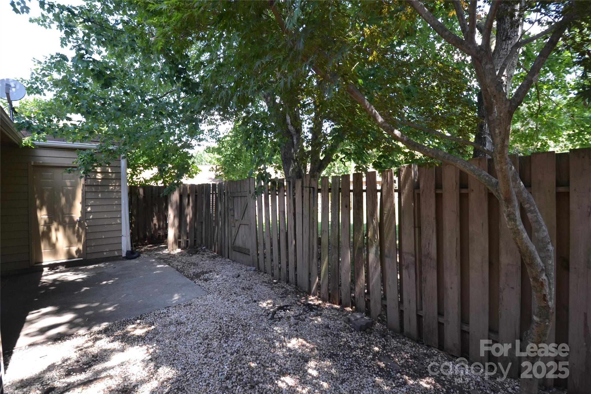 8317 Summer Glen Circle Charlotte, NC 28227 - Photo 30 of 30 a view of a backyard with wooden fence and a large tree