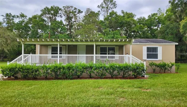 a house with a tree and a garden