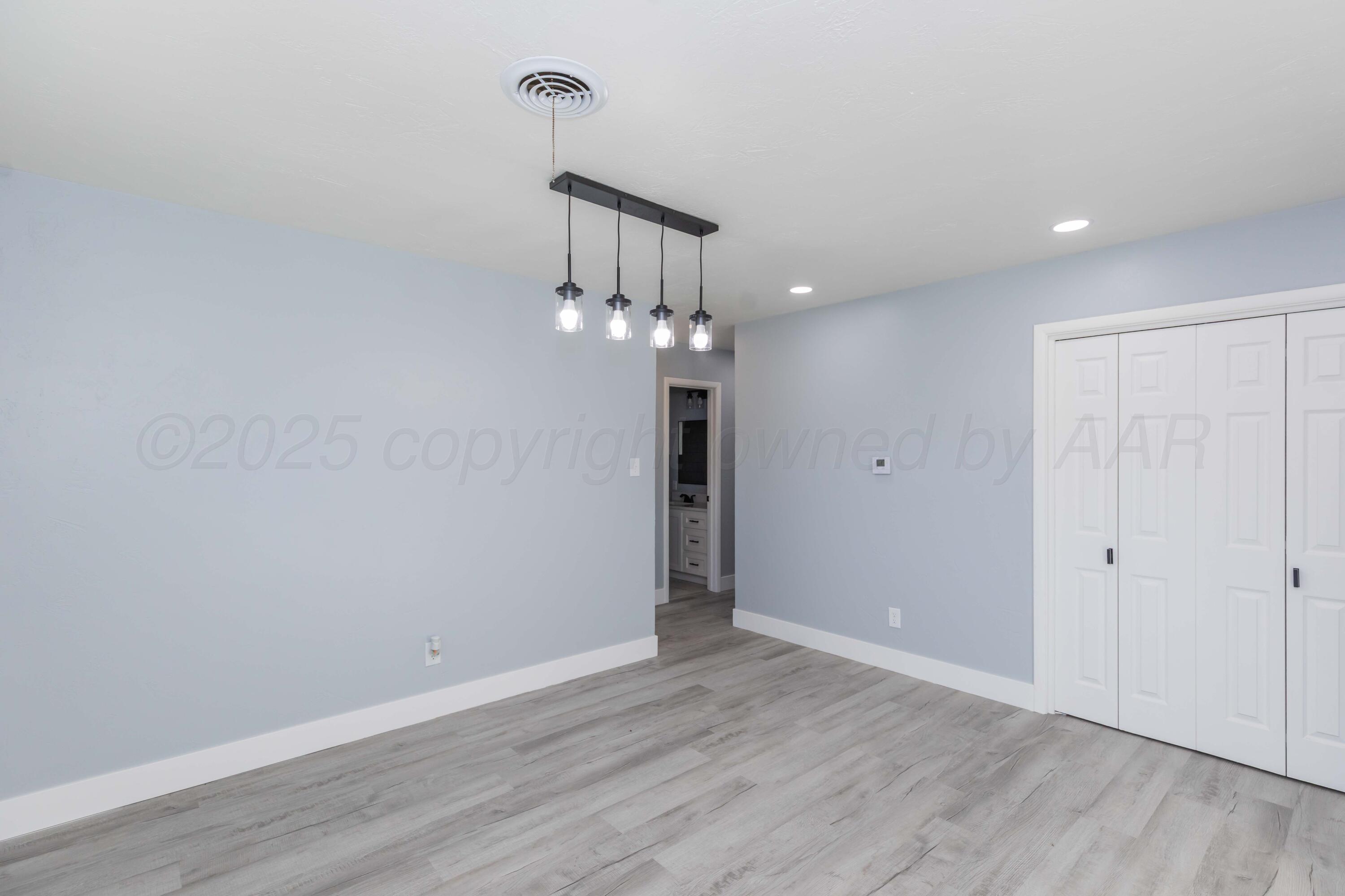 3108 Oak Drive Amarillo, TX 79107 - Photo 11 of 35 wooden floor in an empty room with a window