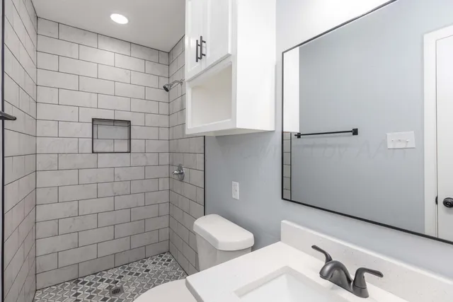 a bathroom with a sink toilet and shower