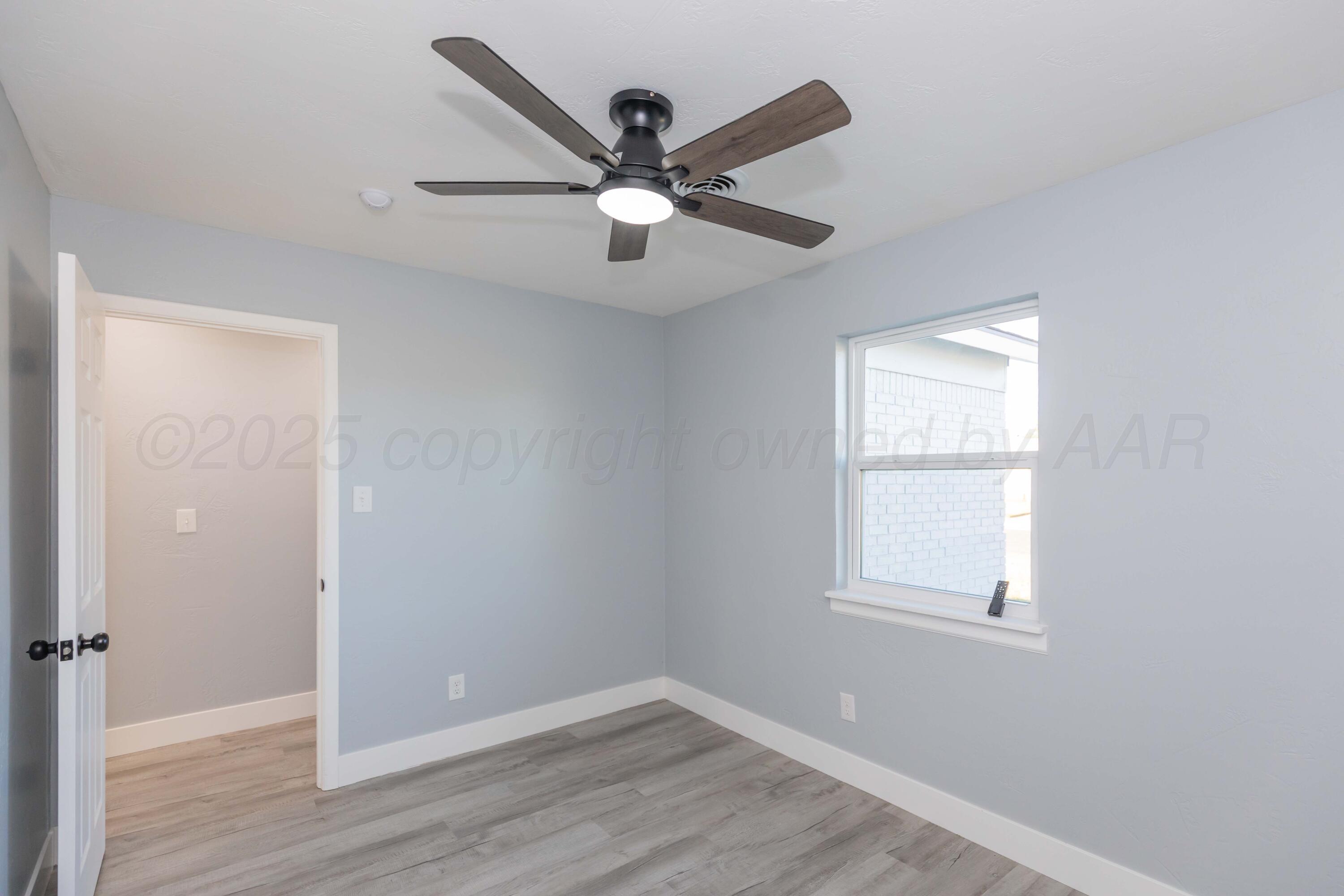 3108 Oak Drive Amarillo, TX 79107 - Photo 25 of 35 wooden floor in an empty room with a window