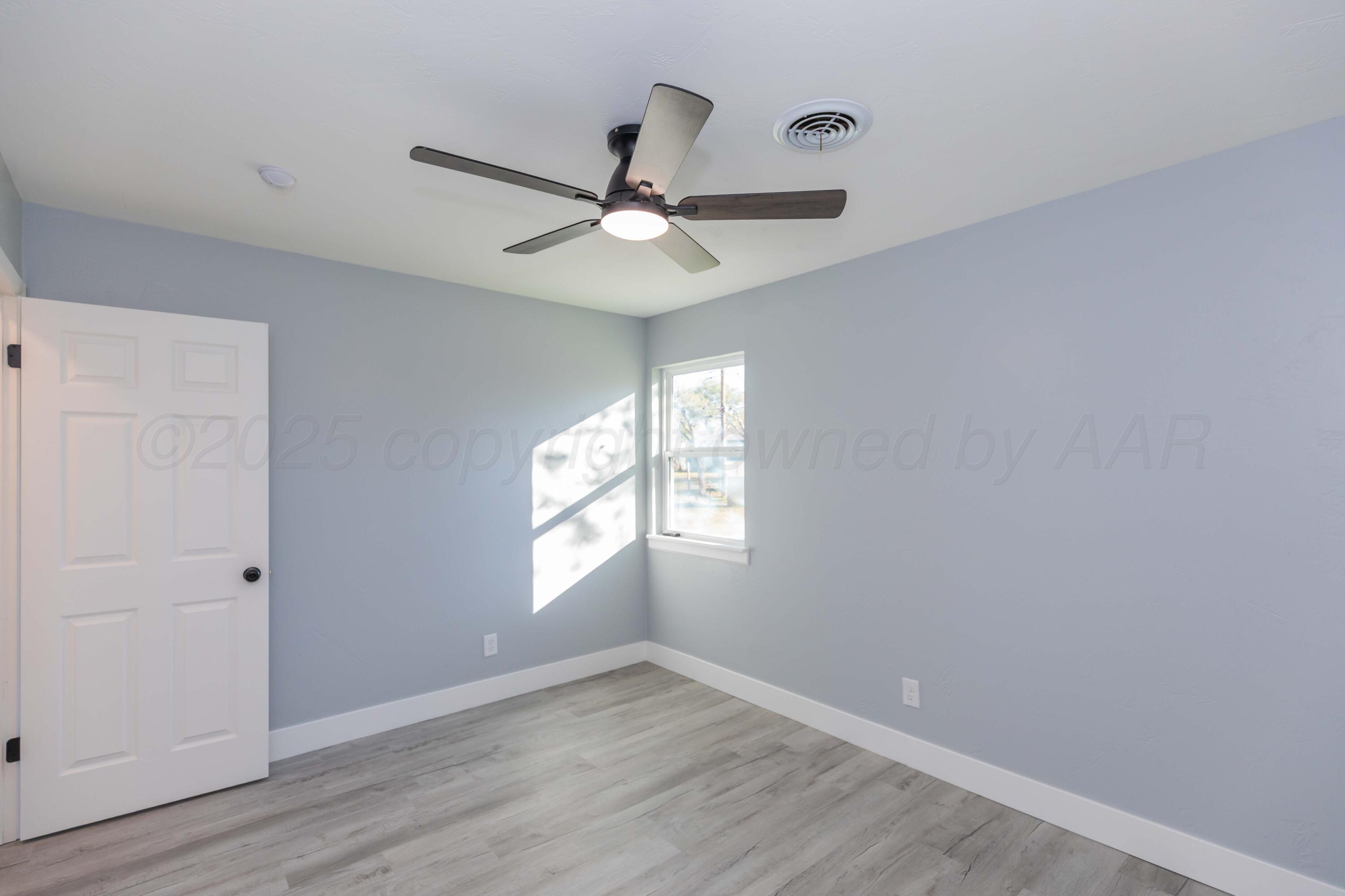 3108 Oak Drive Amarillo, TX 79107 - Photo 27 of 35 wooden floor in an empty room with a window