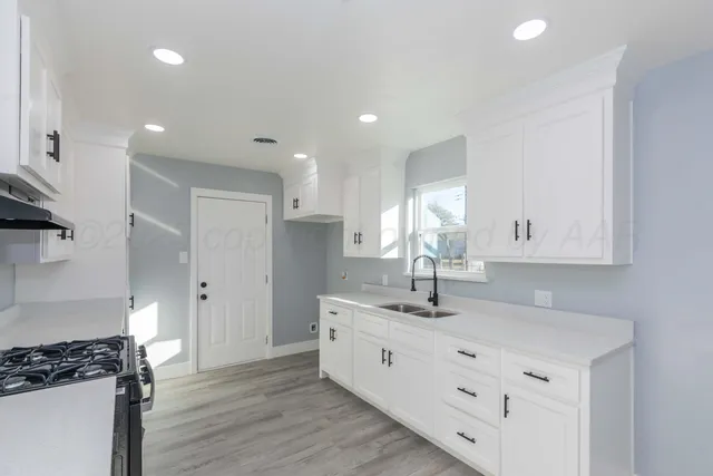 a kitchen with a sink and cabinets