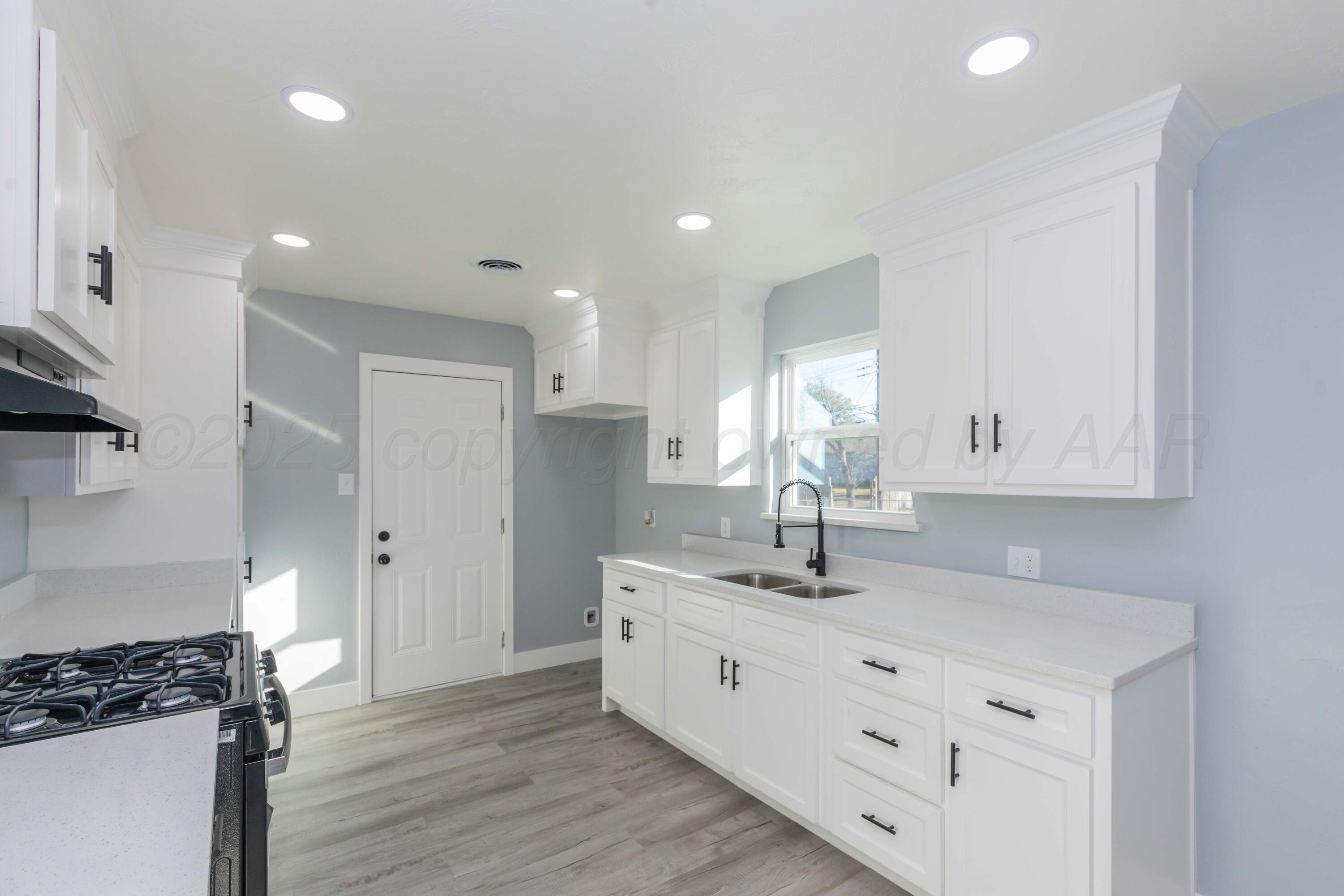 3108 Oak Drive Amarillo, TX 79107 - Photo 3 of 35 a kitchen with a sink and cabinets