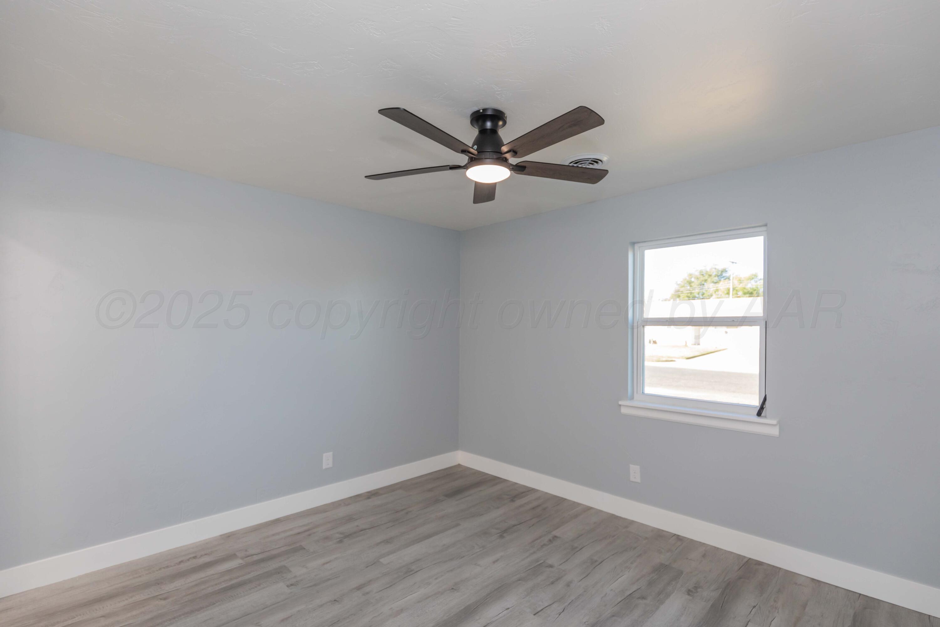 3108 Oak Drive Amarillo, TX 79107 - Photo 33 of 35 wooden floor in an empty room with a window