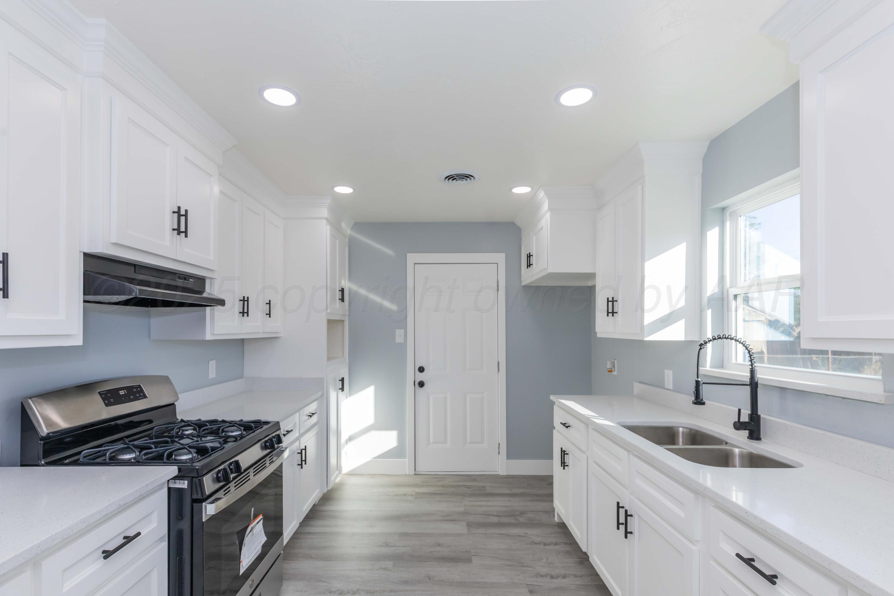 3108 Oak Drive Amarillo, TX 79107 - Photo 4 of 35 a kitchen with stainless steel appliances a sink stove and cabinets