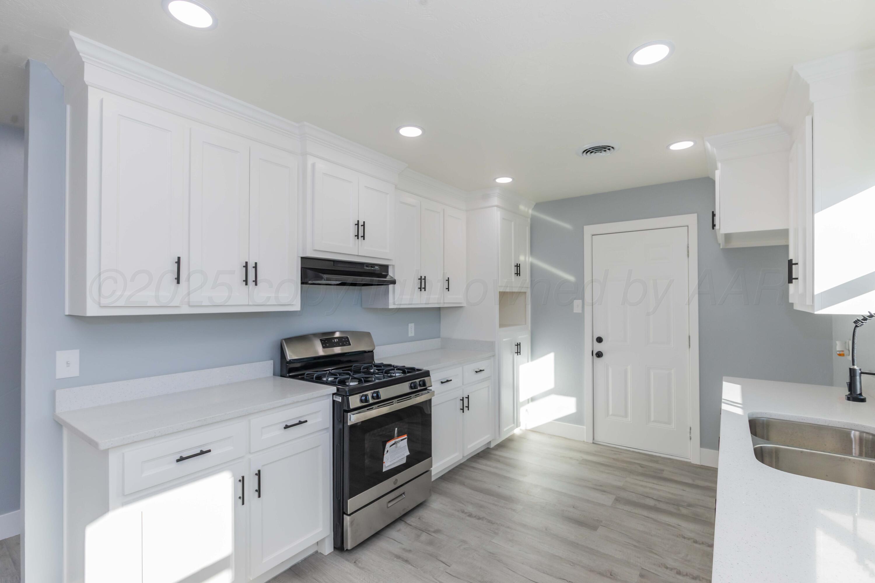3108 Oak Drive Amarillo, TX 79107 - Photo 5 of 35 a kitchen with granite countertop a sink a stove and cabinets