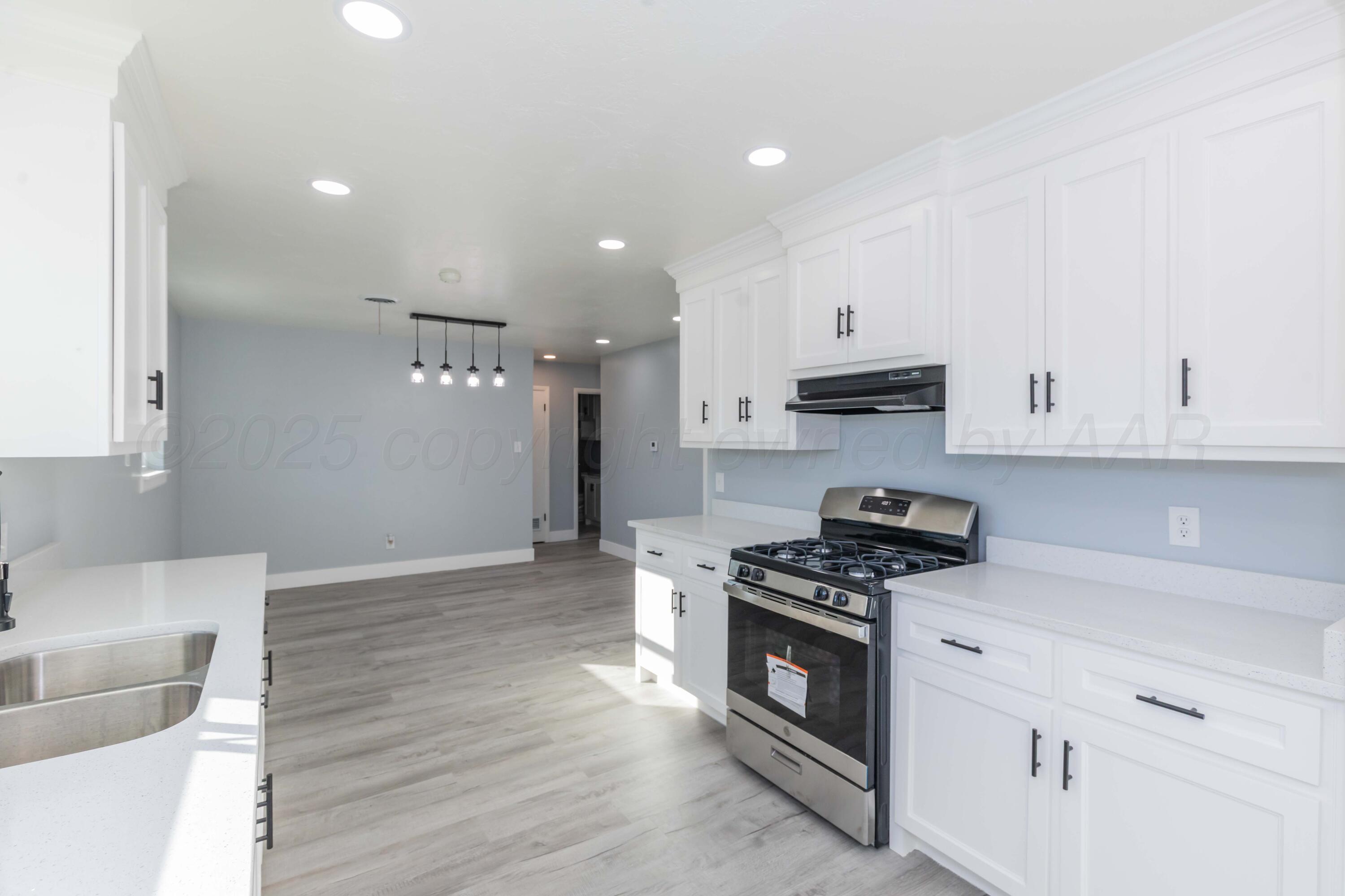 3108 Oak Drive Amarillo, TX 79107 - Photo 6 of 35 a kitchen with stainless steel appliances granite countertop a stove a sink and a refrigerator