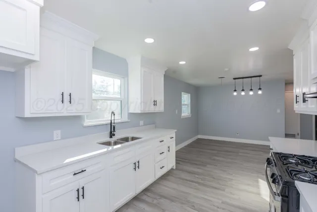 a kitchen with a sink cabinets and window
