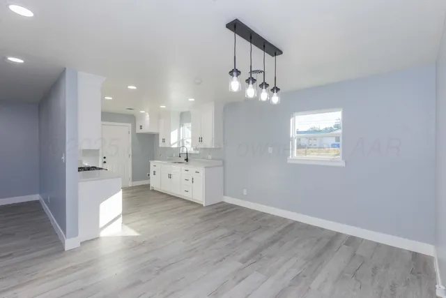 a view of a kitchen with marble kitchen and stainless steel appliances