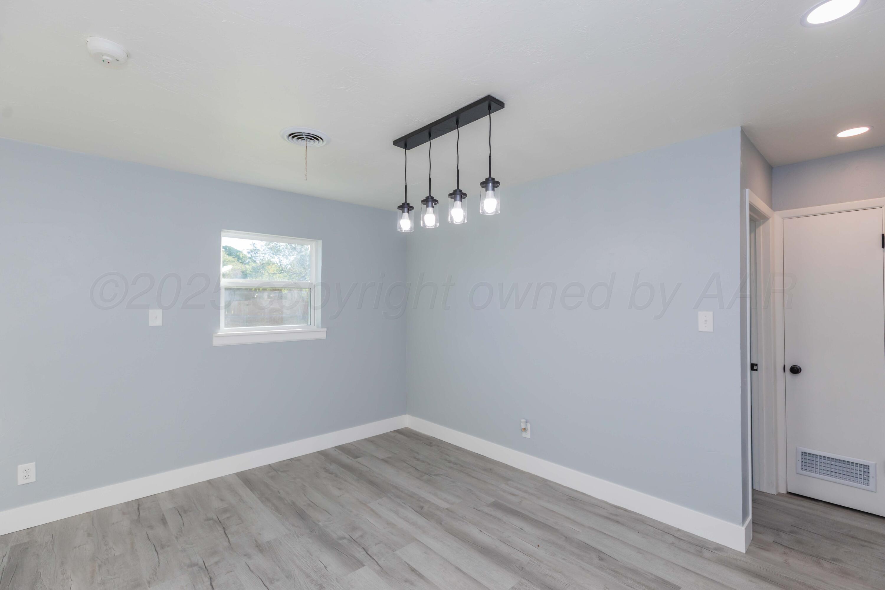 3108 Oak Drive Amarillo, TX 79107 - Photo 10 of 35 wooden floor in an empty room with a window