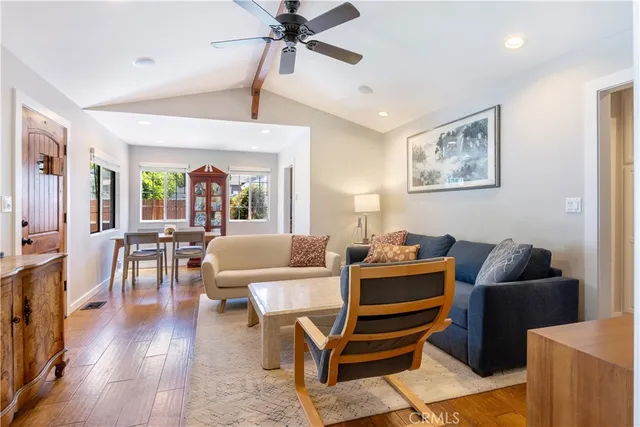 a living room with furniture and wooden floor