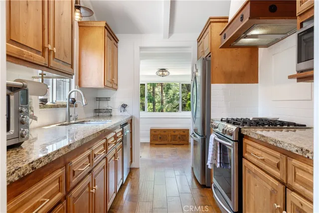 a kitchen with stainless steel appliances granite countertop a stove and a sink