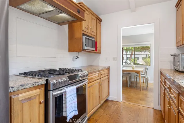 a kitchen with stainless steel appliances granite countertop a stove and a sink
