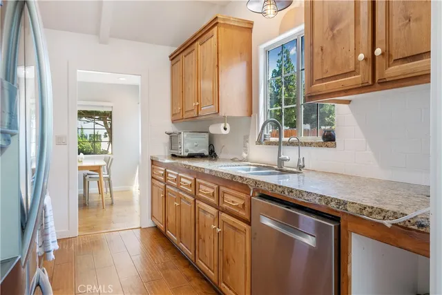 a kitchen with stainless steel appliances granite countertop a sink and a cabinets