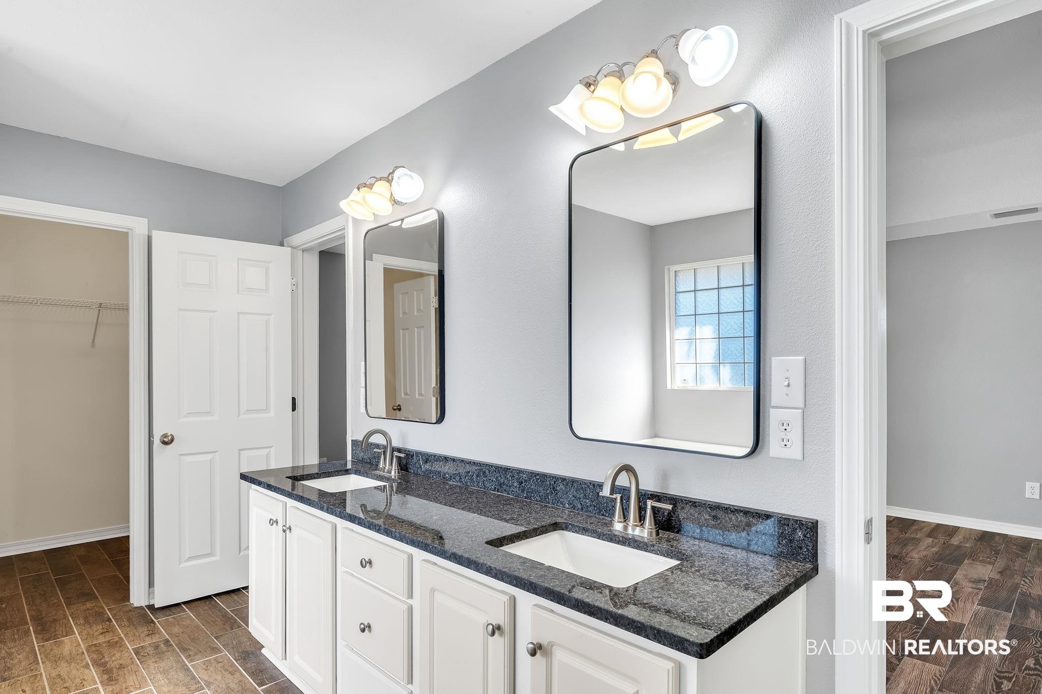 16444 Hamlet Lane Foley, AL 36535 - Photo 27 of 49 Full bathroom featuring wood tiled floor, visible vents, and a sink