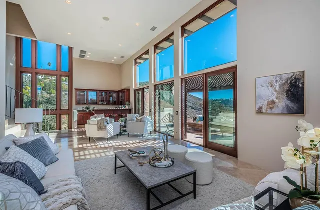 a kitchen with stainless steel appliances kitchen island granite countertop a table chairs sink and stove top oven with wooden floor