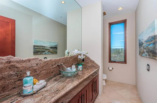 a bedroom with furniture and a large window