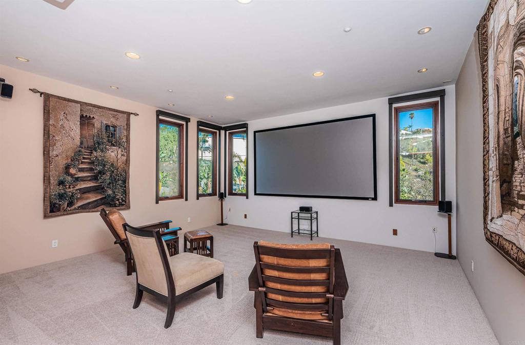 2362 Edgehill Road Vista, CA 92084 - Photo 34 of 63 a living room with furniture a projector and a flat screen tv