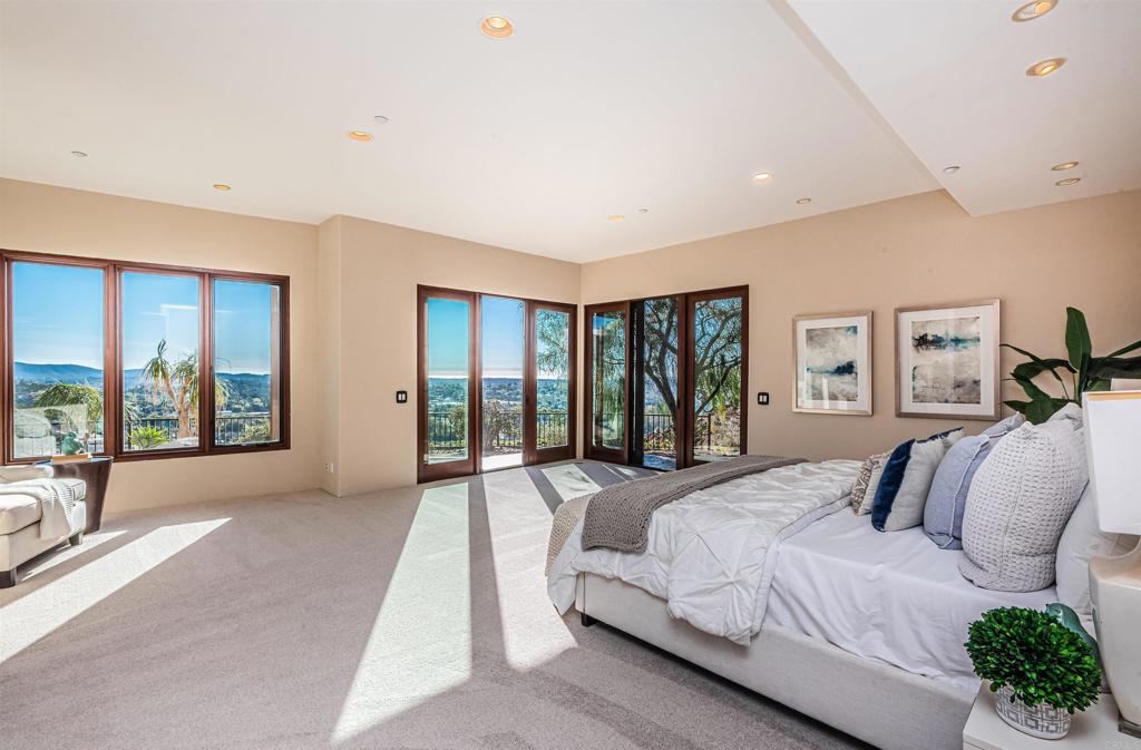 2362 Edgehill Road Vista, CA 92084 - Photo 35 of 63 a spacious bedroom with a large bed and a large window