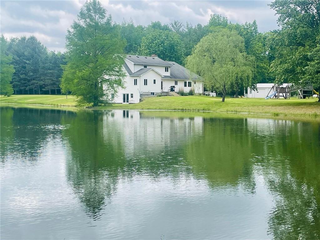 a view of lake with houses in background