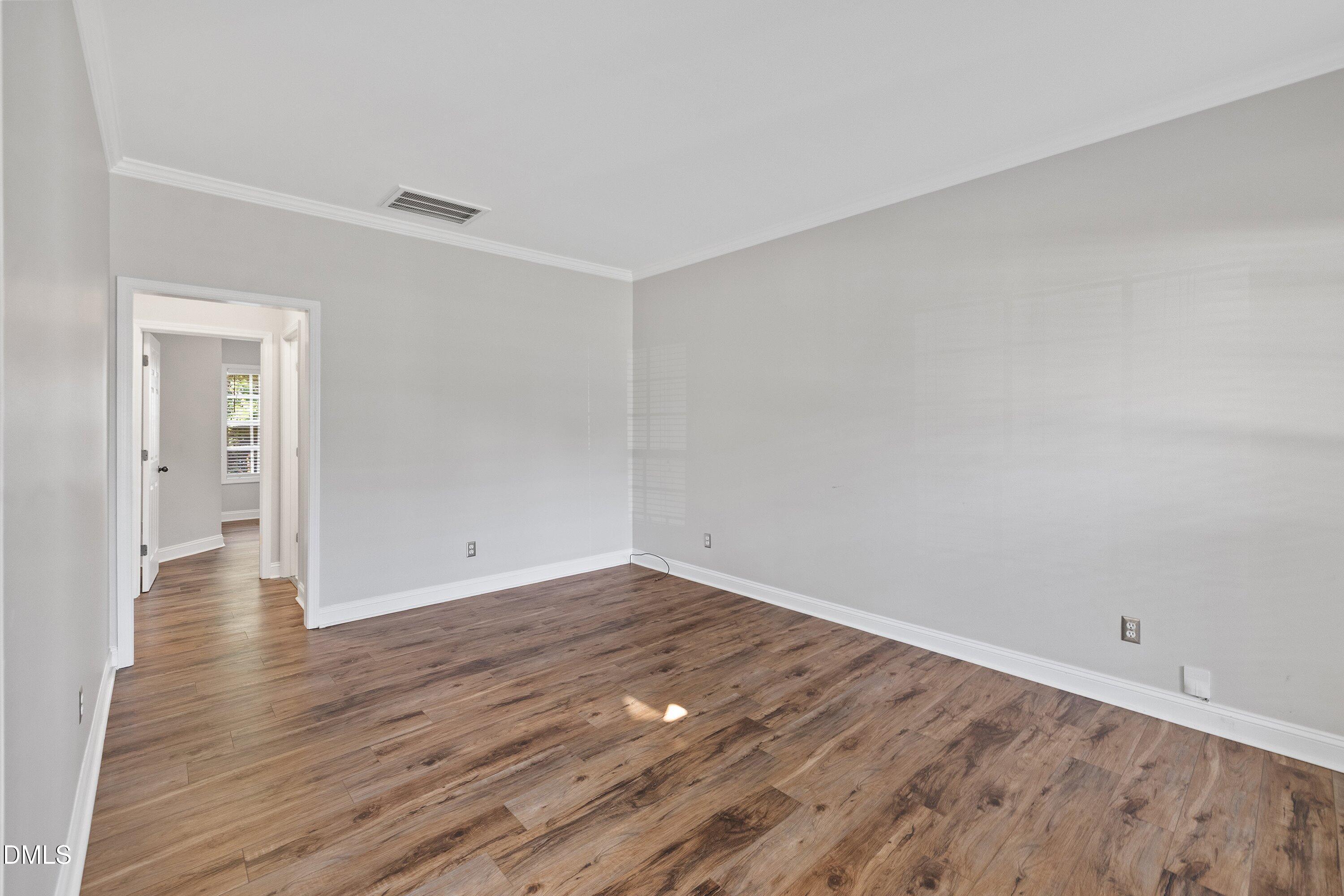 3717 Windmeade Road Wake Forest, NC 27587 - Photo 11 of 51 a view of an empty room and wooden floor