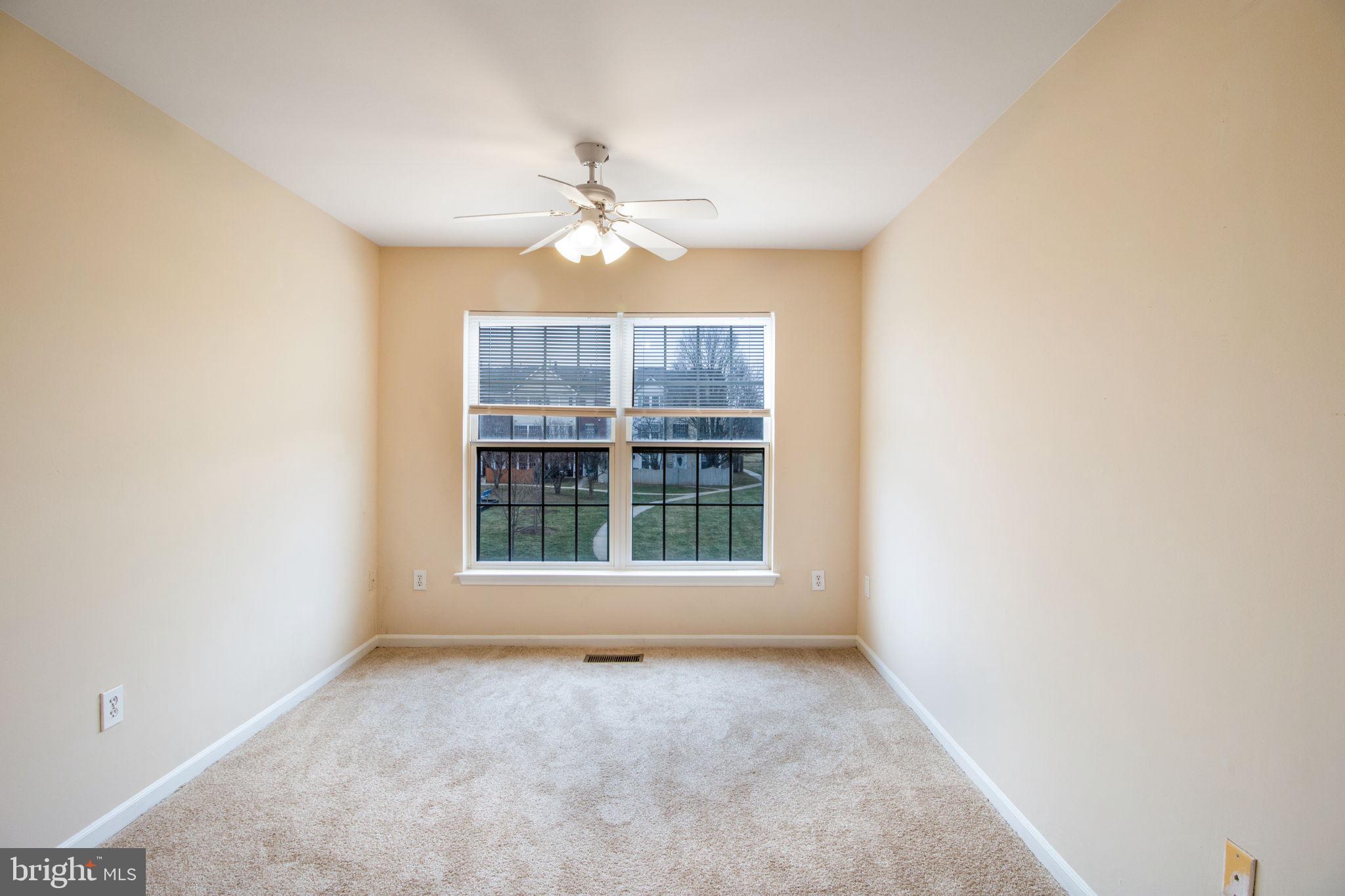 5171 Duke Court Frederick, MD 21703 - Photo 15 of 26 an empty room with windows and ceiling fan