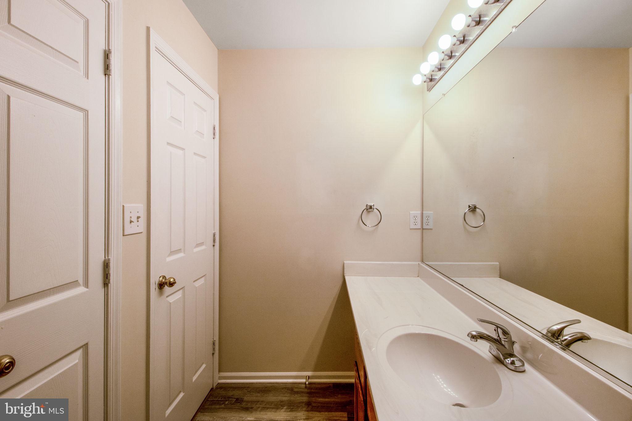5171 Duke Court Frederick, MD 21703 - Photo 18 of 26 a bathroom with a sink a toilet and shower