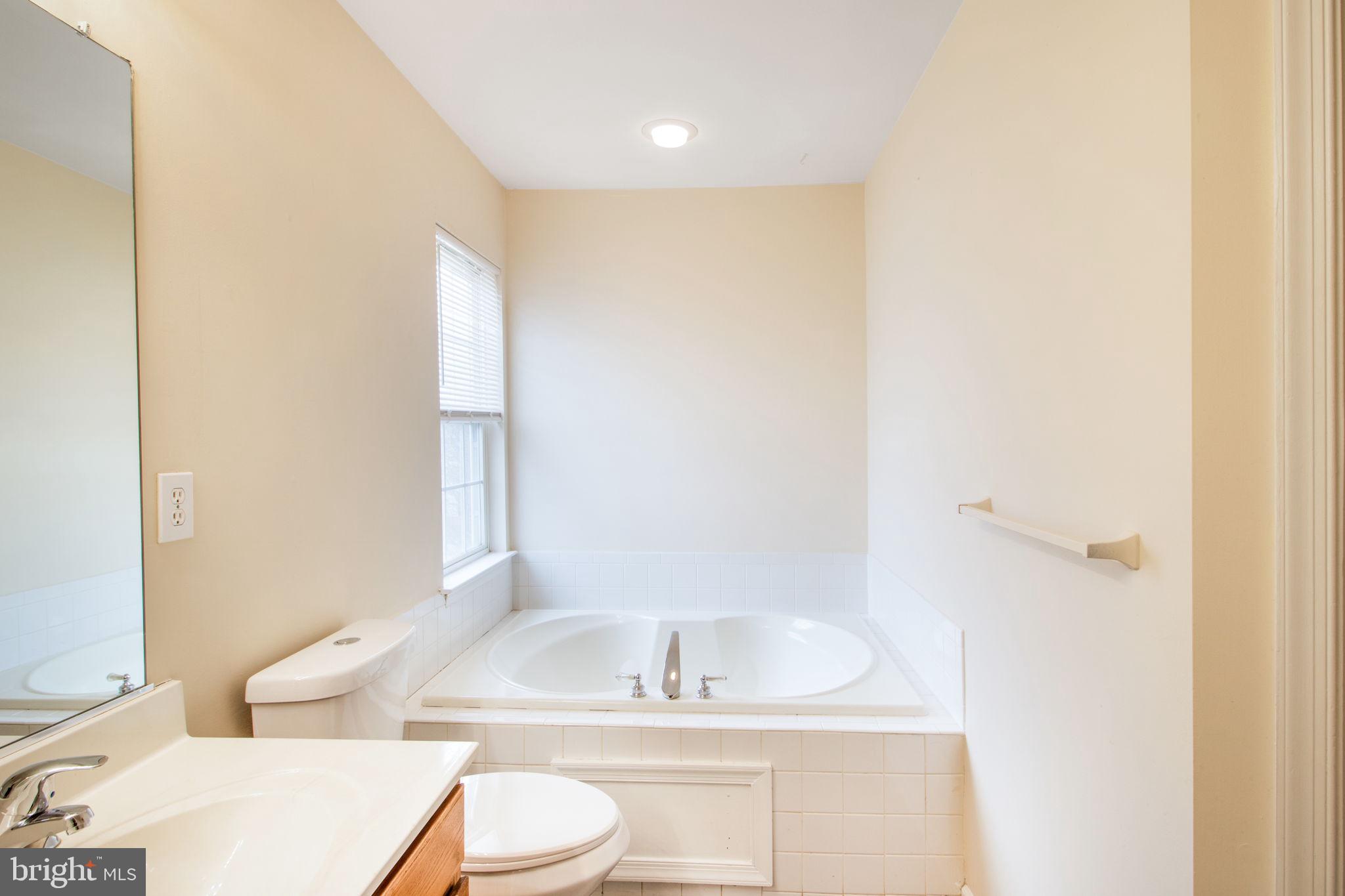 5171 Duke Court Frederick, MD 21703 - Photo 23 of 26 a bathroom with a granite countertop sink toilet and shower