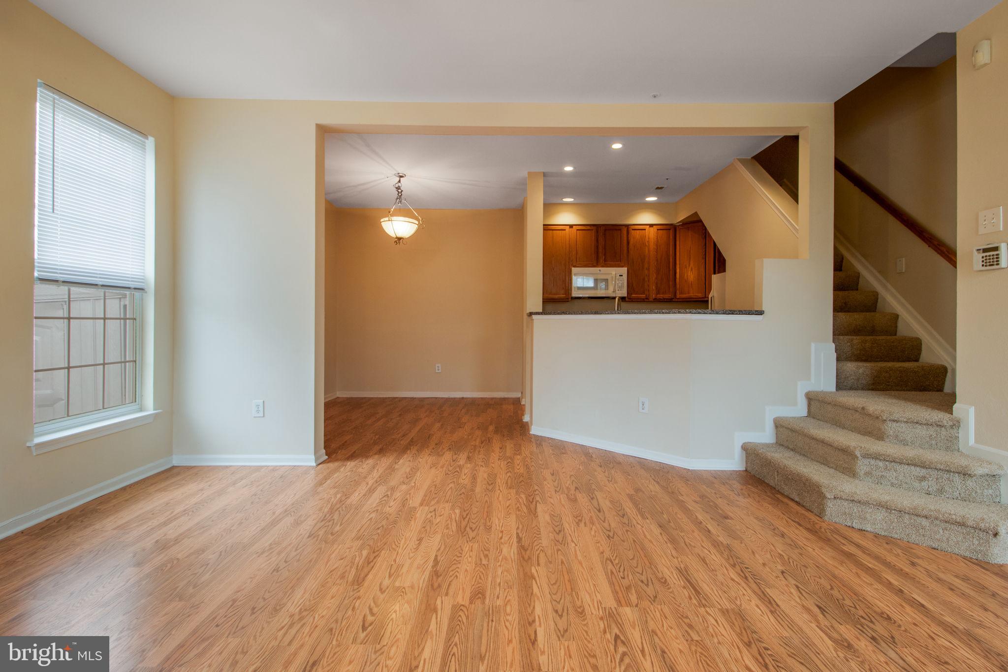 5171 Duke Court Frederick, MD 21703 - Photo 3 of 26 a view of a hallway with wooden floor and staircase