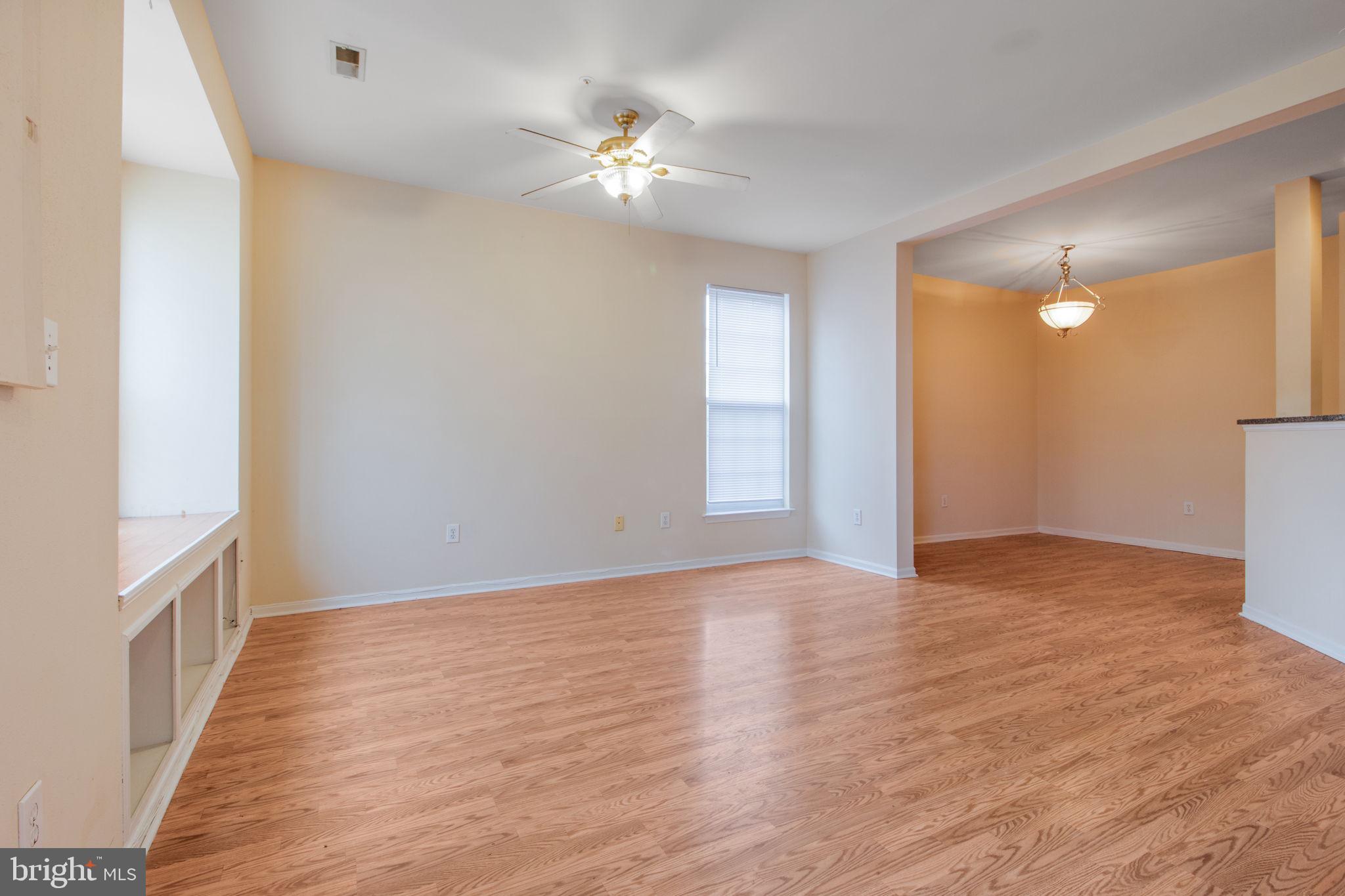 5171 Duke Court Frederick, MD 21703 - Photo 4 of 26 a view of an empty room with wooden floor and a window