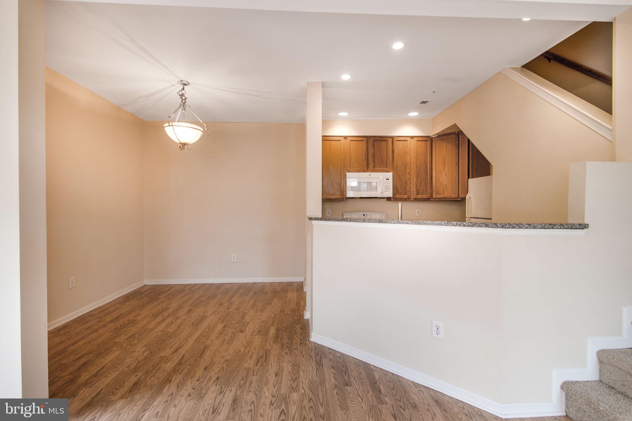 5171 Duke Court Frederick, MD 21703 - Photo 5 of 26 a view of a kitchen cabinets and a wooden floor
