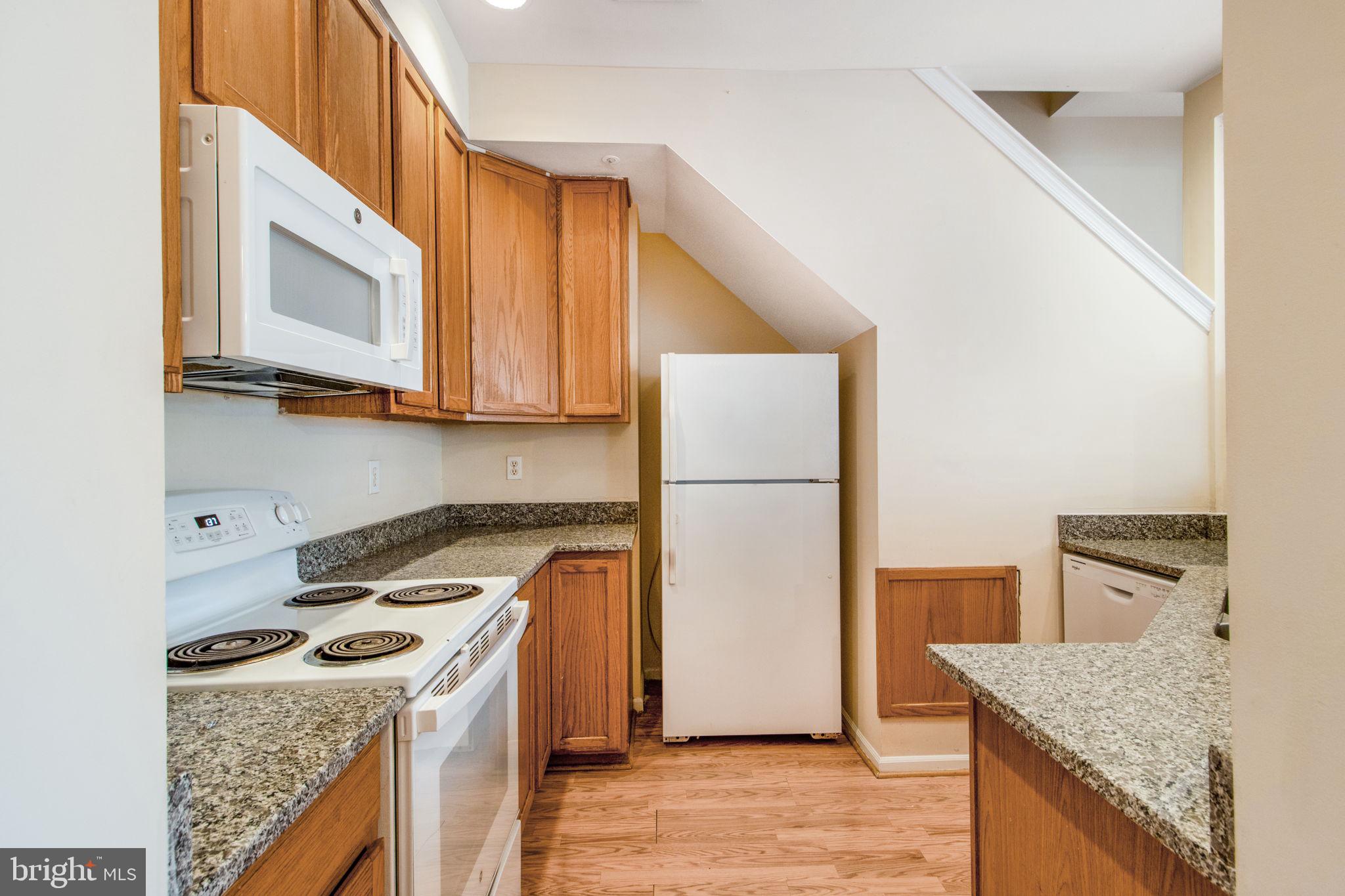 5171 Duke Court Frederick, MD 21703 - Photo 6 of 26 a kitchen with a stove a sink and a refrigerator