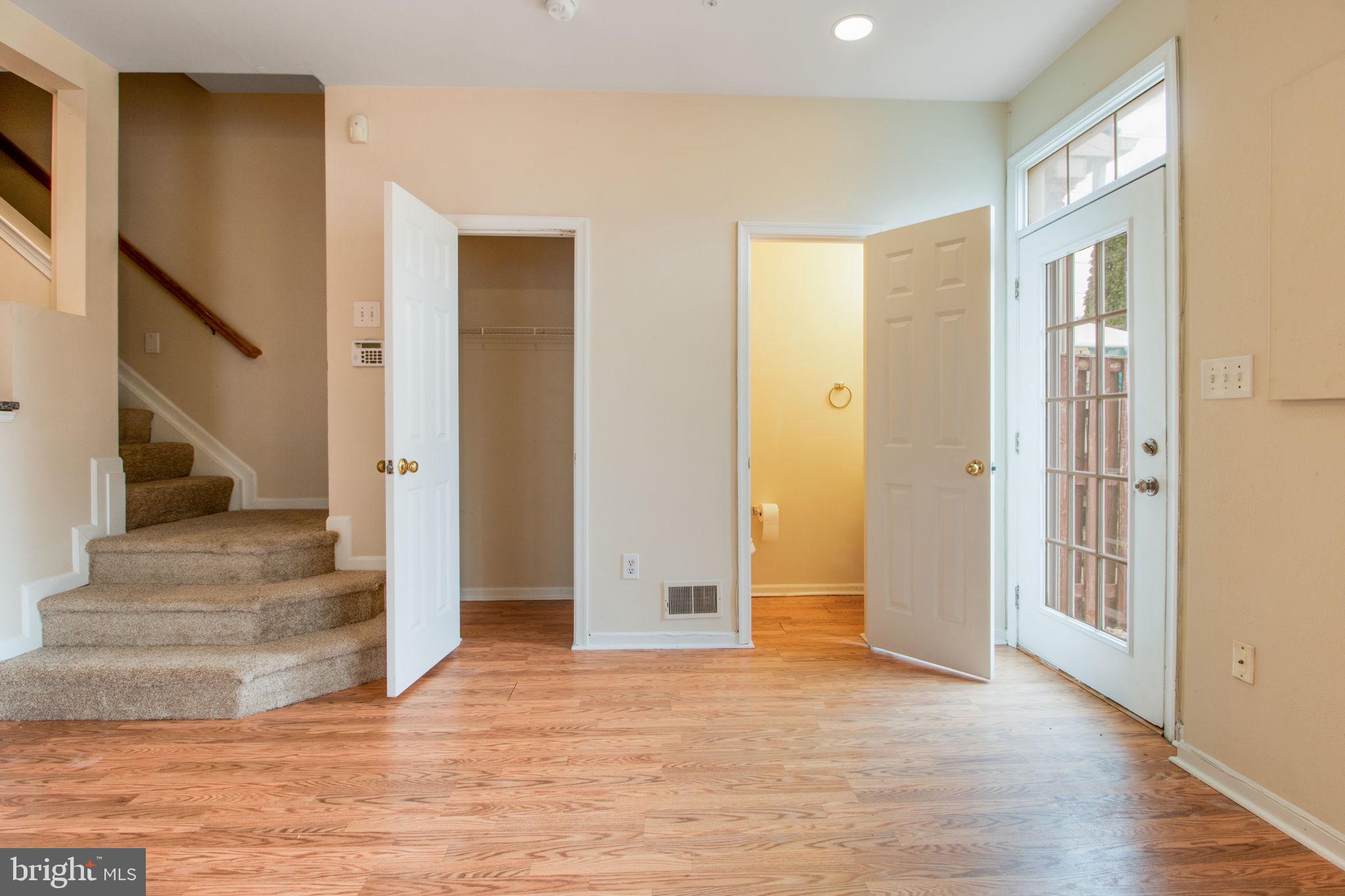 5171 Duke Court Frederick, MD 21703 - Photo 9 of 26 a view of a hallway with wooden floor and staircase