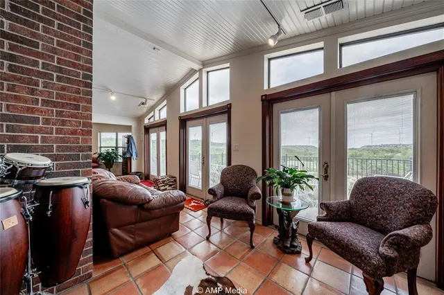 a kitchen with stainless steel appliances granite countertop a refrigerator a sink a stove a microwave and island