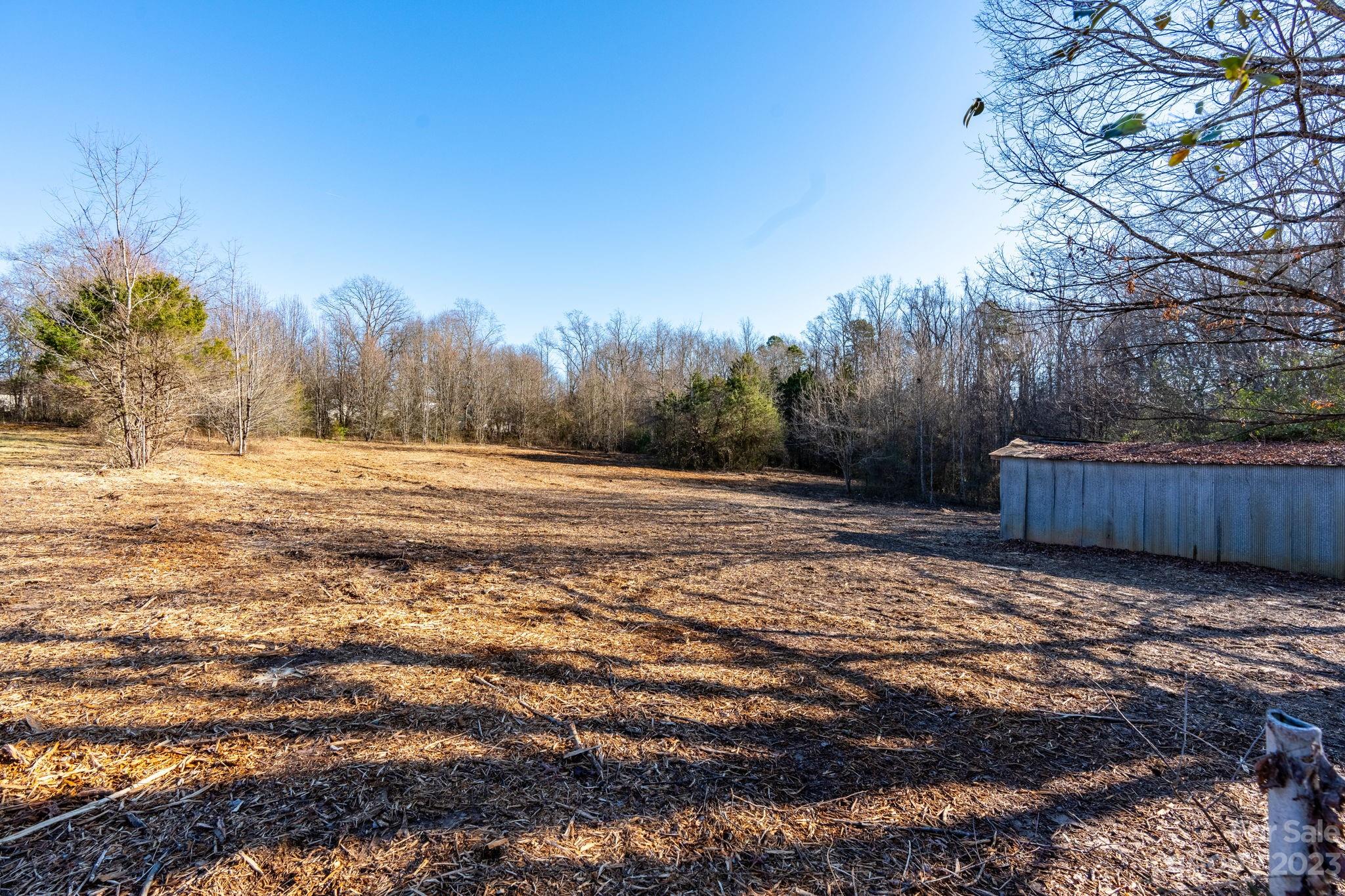 215 Cape Hickory Road Hickory, NC 28601 - Photo 18 of 34 a view of a yard with trees and wooden fence