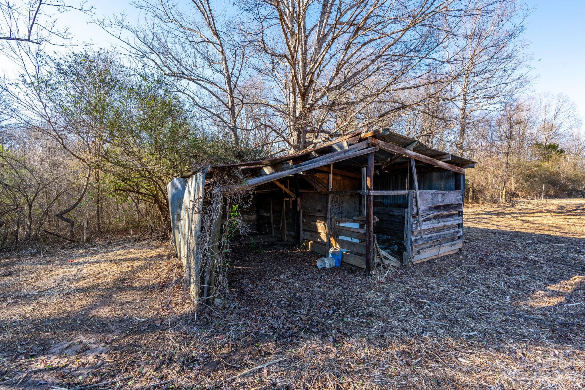 215 Cape Hickory Road Hickory, NC 28601 - Photo 20 of 34 a view of a wooden house with a yard and large trees