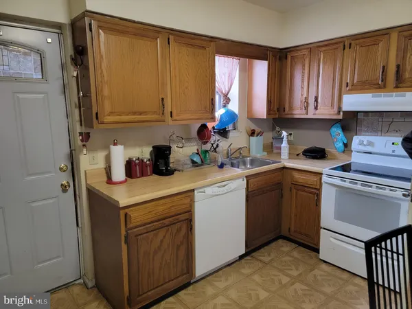 a kitchen with a sink cabinets and window