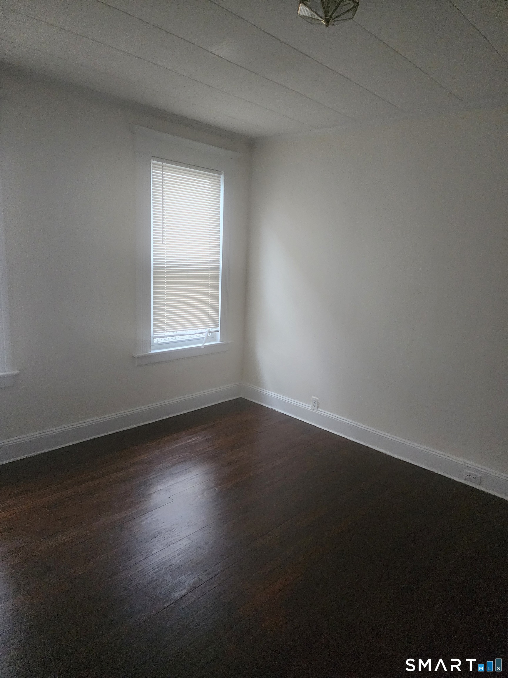 2744 Main Street Bridgeport, CT 06606 - Photo 11 of 12 a view of an empty room with wooden floor and a window