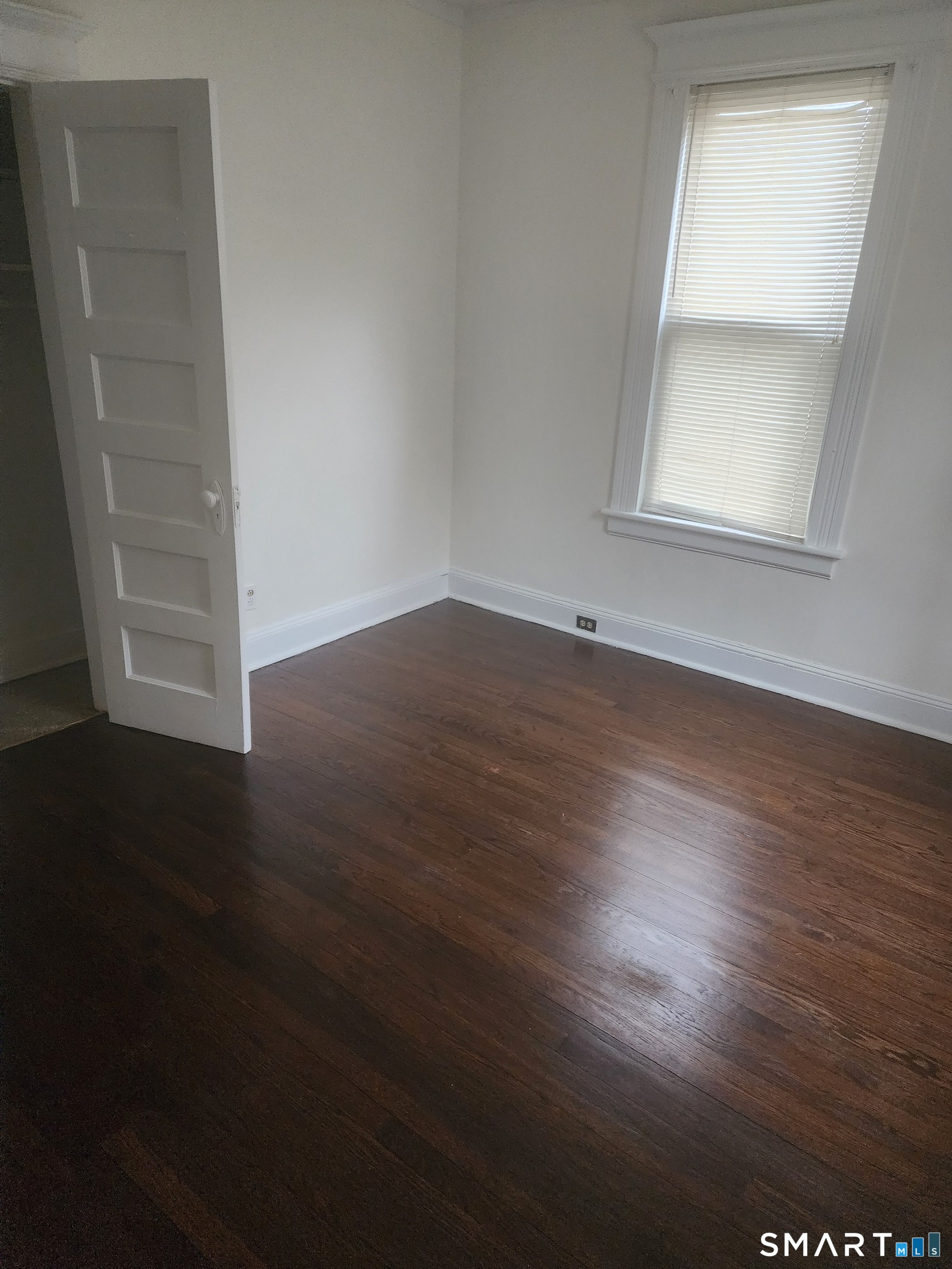 2744 Main Street Bridgeport, CT 06606 - Photo 7 of 12 an empty room with wooden floor and windows