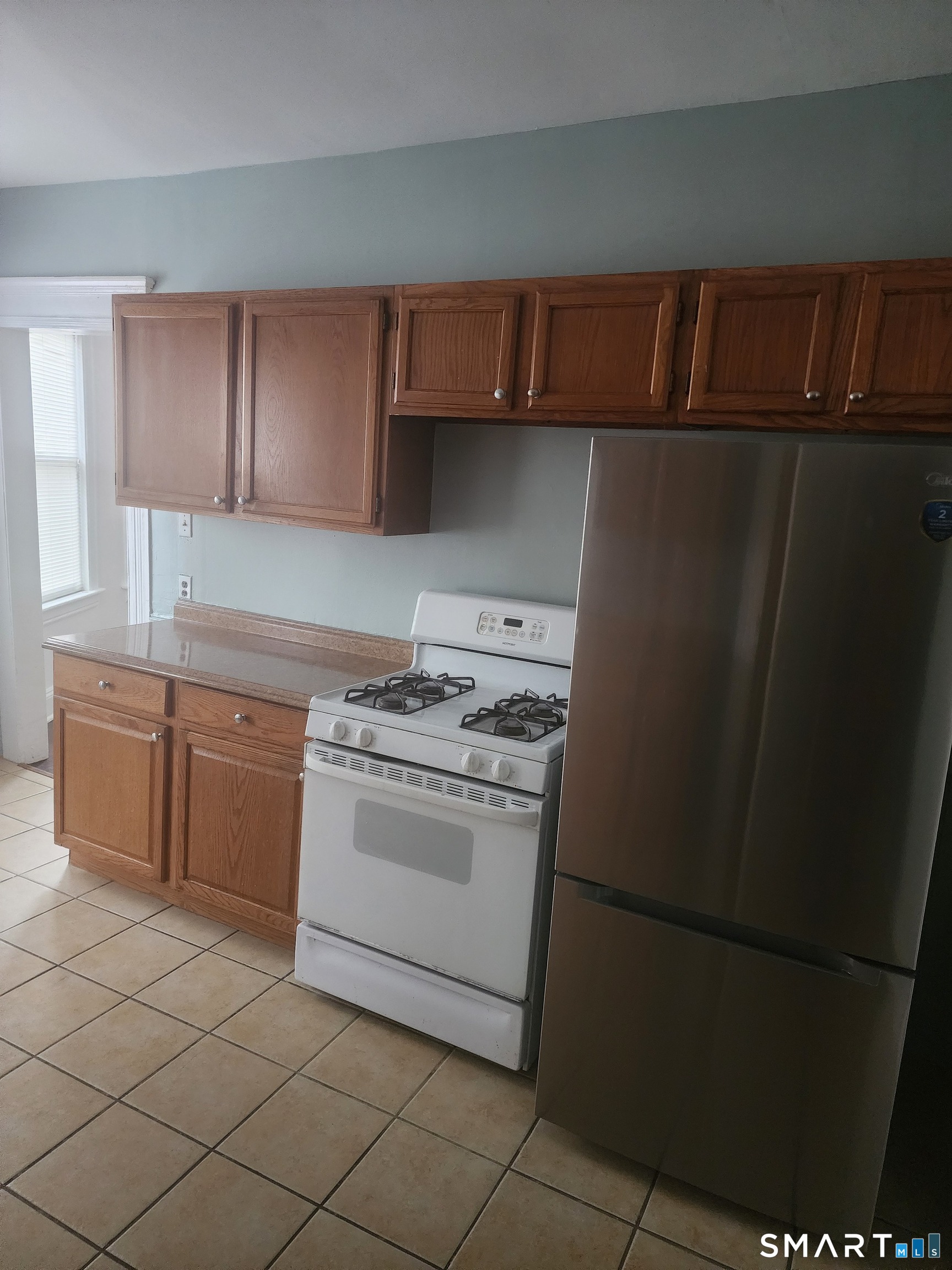 2744 Main Street Bridgeport, CT 06606 - Photo 8 of 12 a kitchen with a stove top oven and cabinets