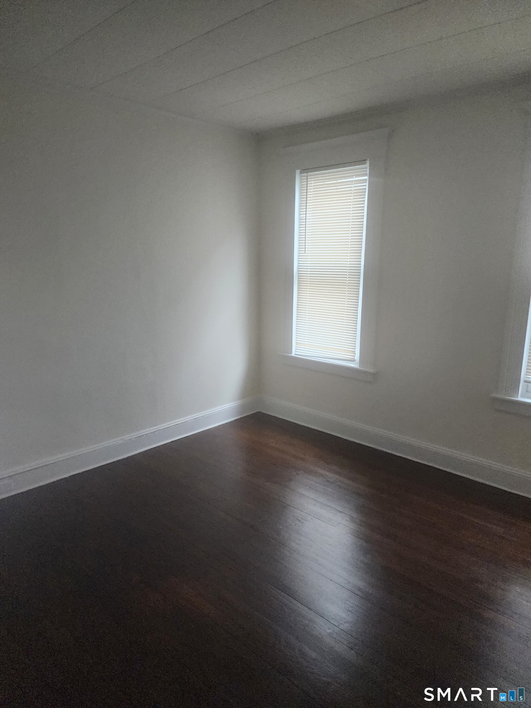 2744 Main Street Bridgeport, CT 06606 - Photo 9 of 12 a view of an empty room with wooden floor and a window