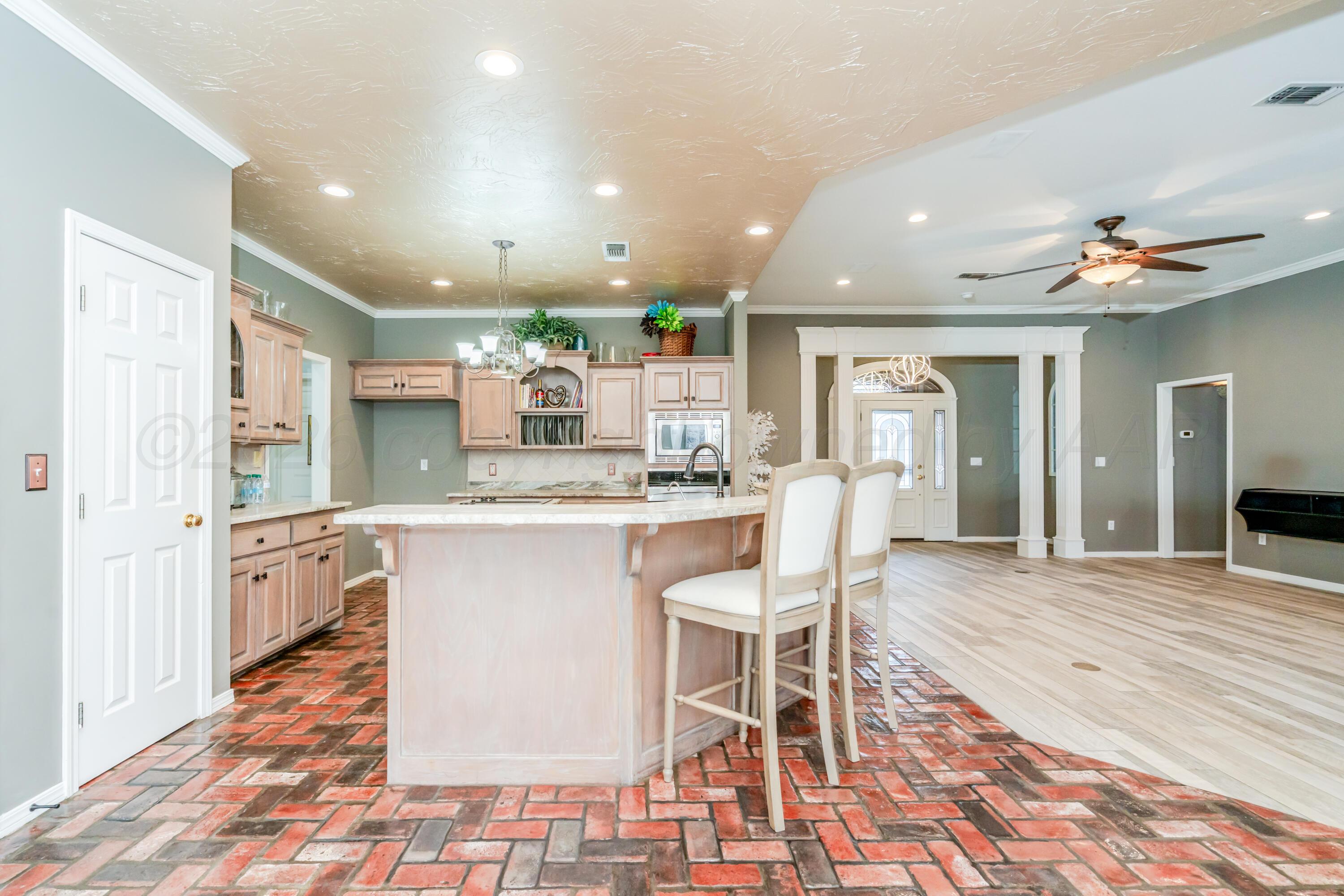 8216 Progress Drive Amarillo, TX 79119 - Photo 23 of 66 a kitchen with stainless steel appliances kitchen island granite countertop a table and chairs in it