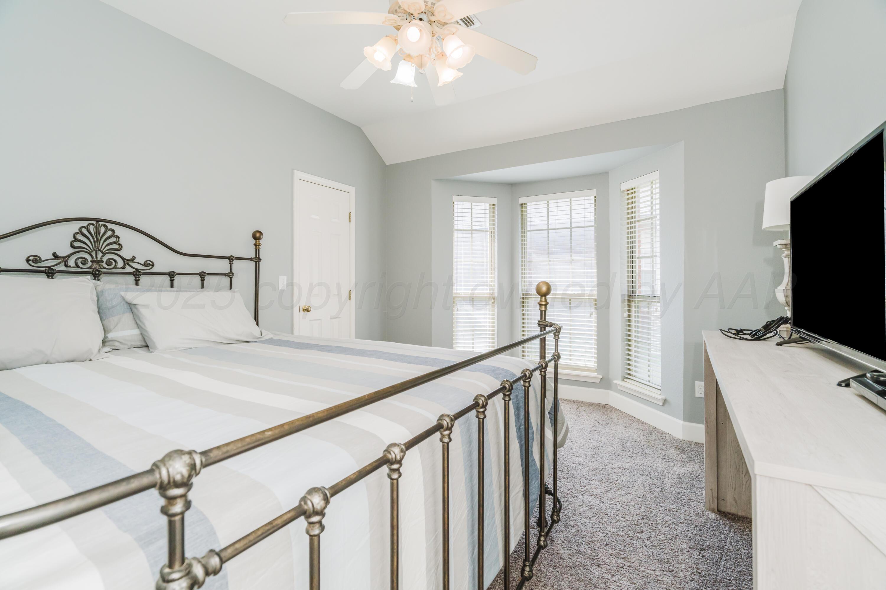 8216 Progress Drive Amarillo, TX 79119 - Photo 27 of 58 a bedroom with a bed and a flat tv screen on dresser
