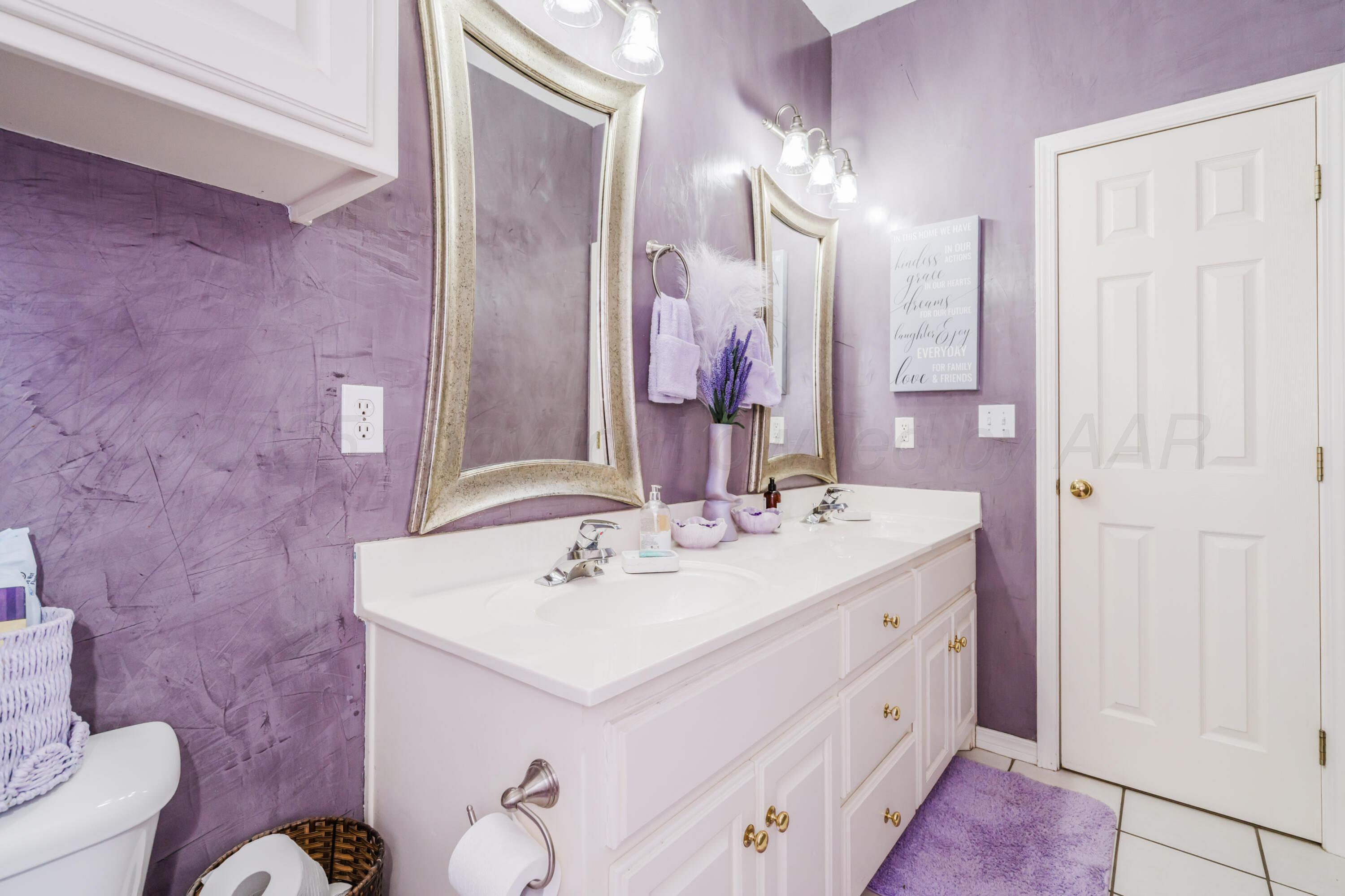 8216 Progress Drive Amarillo, TX 79119 - Photo 31 of 58 a bathroom with a sink vanity and a mirror