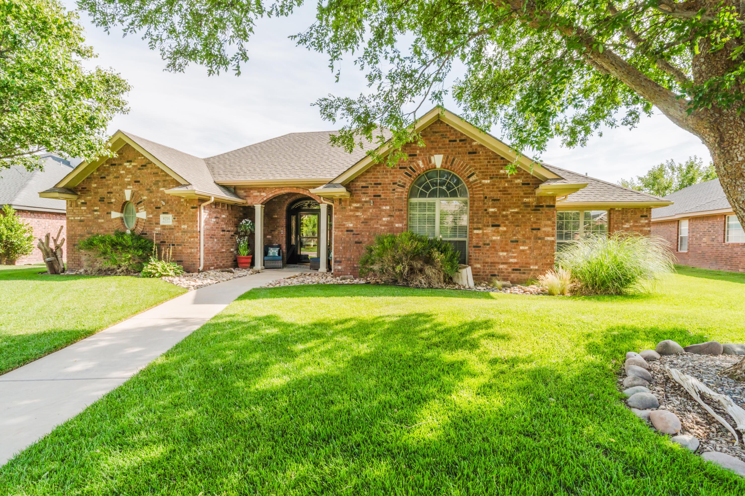 8216 Progress Drive Amarillo, TX 79119 - Photo 4 of 58 a front view of a house with garden