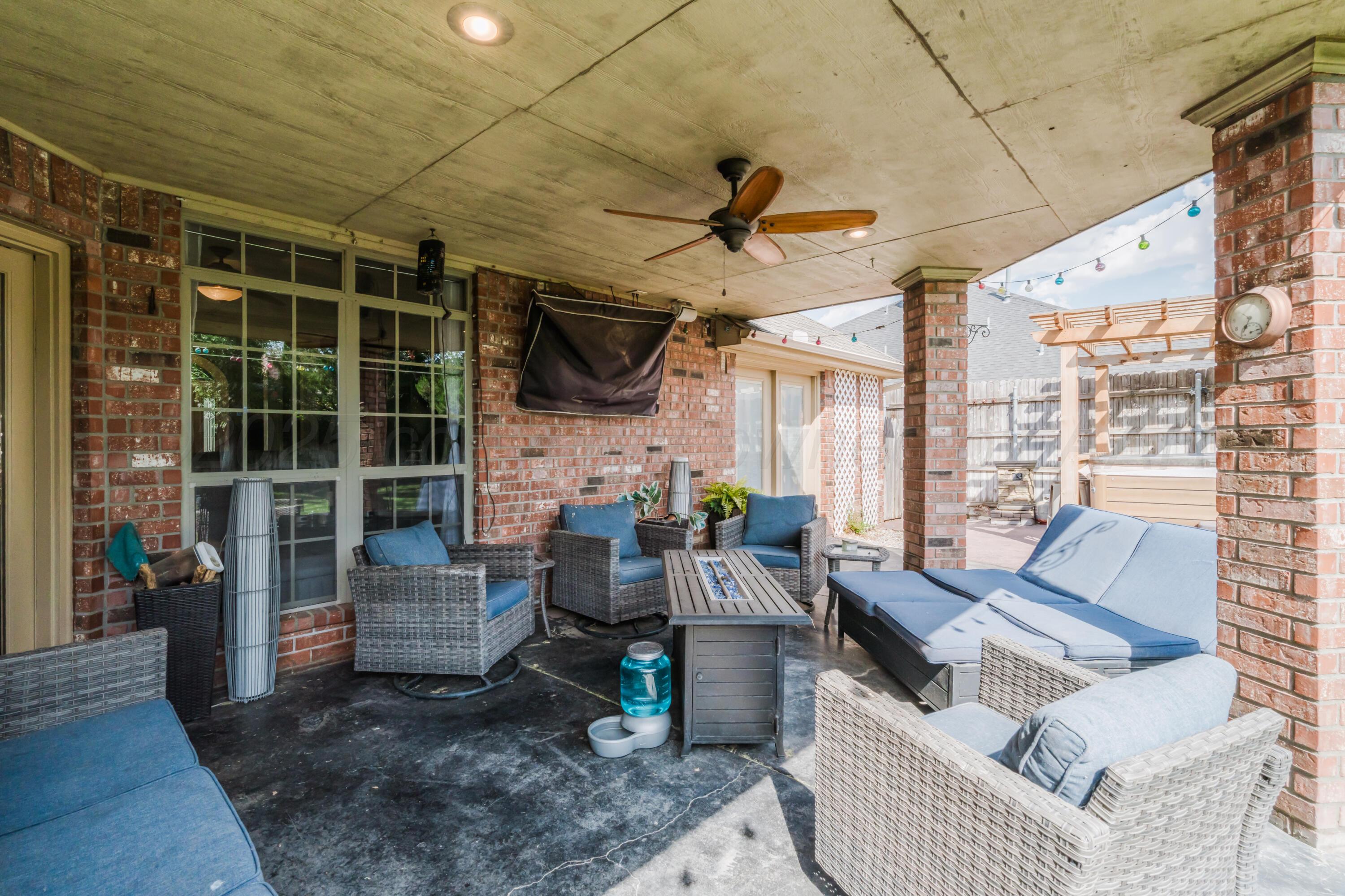 8216 Progress Drive Amarillo, TX 79119 - Photo 49 of 58 a living room with furniture a flat screen tv and a table
