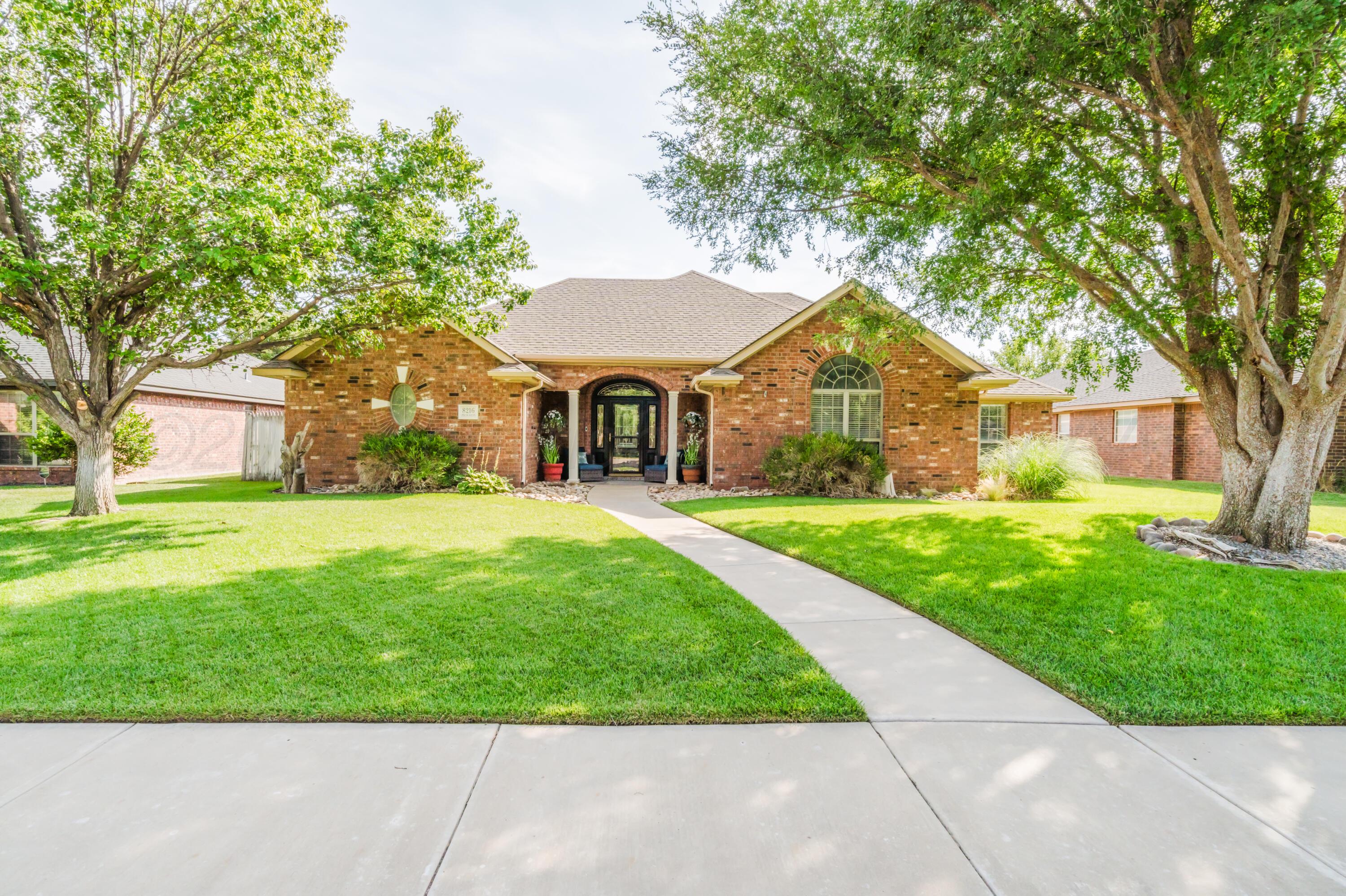 8216 Progress Drive Amarillo, TX 79119 - Photo 5 of 58 a front view of a house with garden