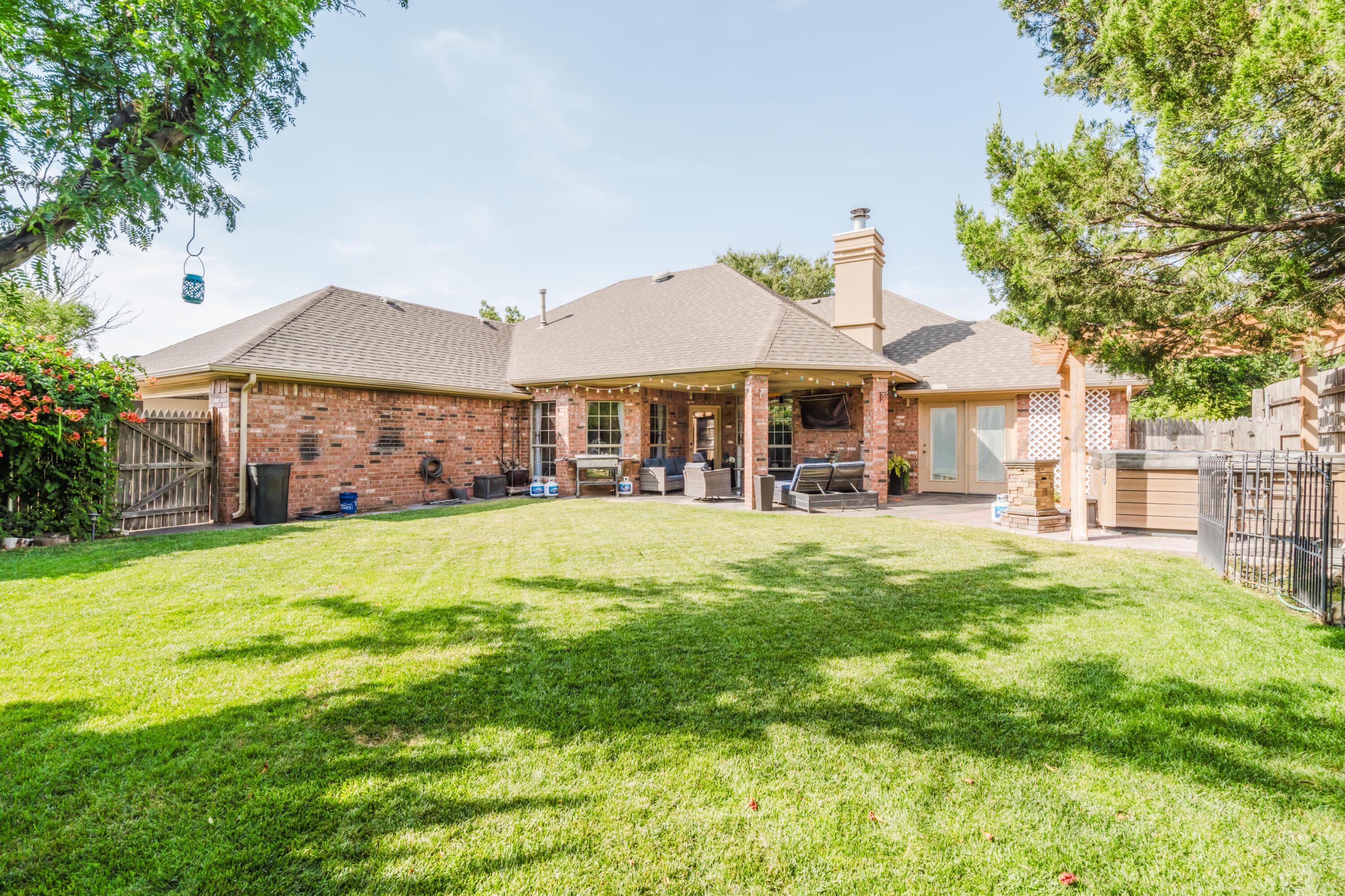 8216 Progress Drive Amarillo, TX 79119 - Photo 54 of 58 a view of a house with a big yard potted plants and large tree