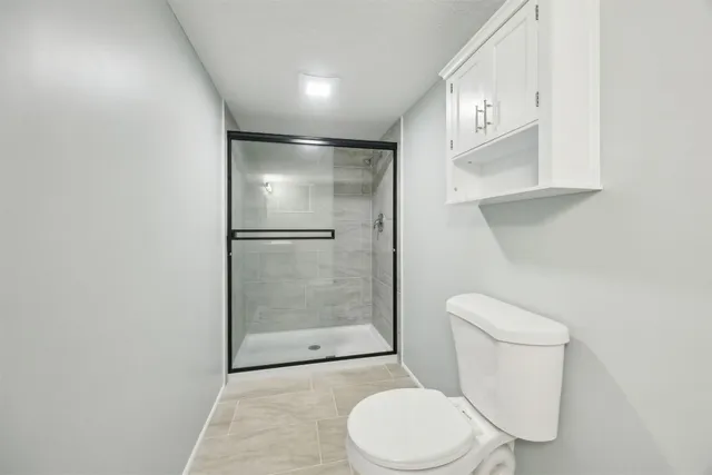 a white toilet sitting next to a bathroom sink